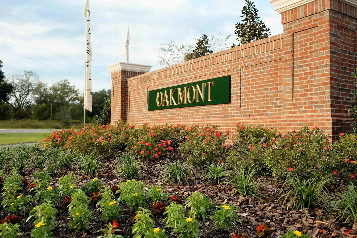 Brick neighborhood entrance sign with fresh annual flower beds