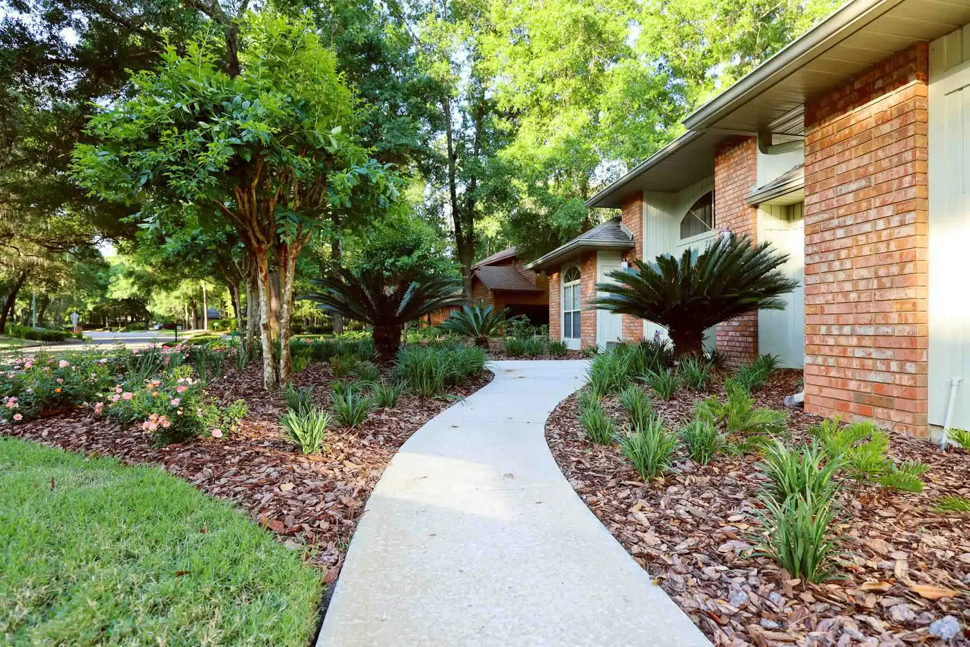 Brick home with a new walkway and freshly planted beds