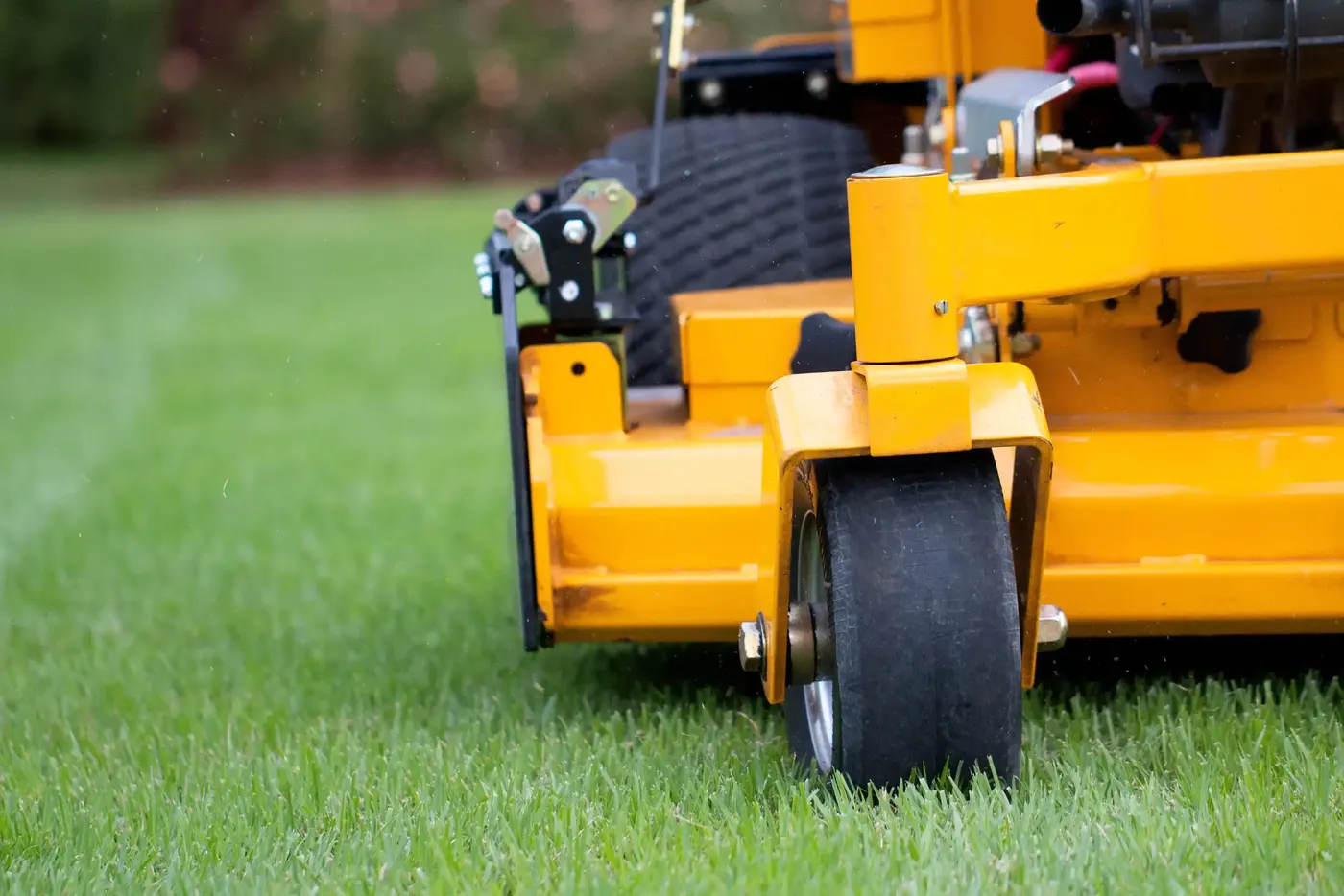 Close view of a commercial mower on a striped lawn